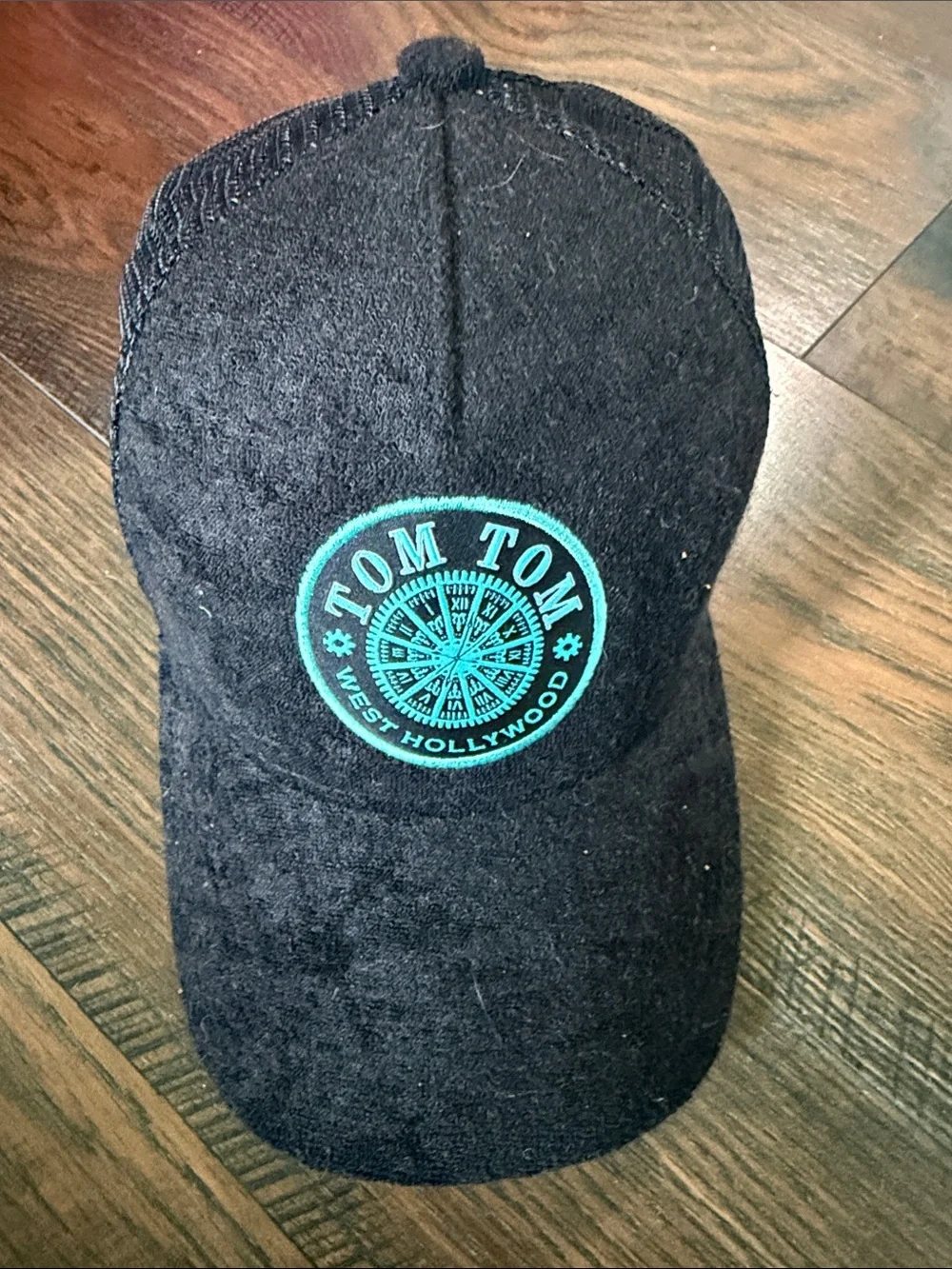 Tom Tom West Hollywood Black Trucker Hat with Teal Logo